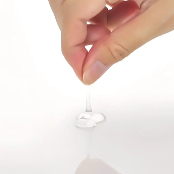 Clear, viscous liquid of Gold Lotion Normal 120ml being squeezed for optimal application