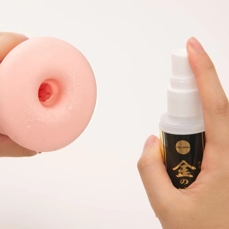Pink Fleshlight and lubricant spray next to Gold Ethanol Disinfectant Spray 100ml
