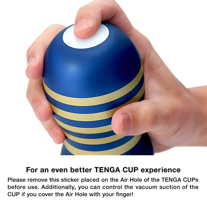 Blue and gold striped pleasure object in TENGA PREMIUM SOFT CASE CUP with vacuum hole