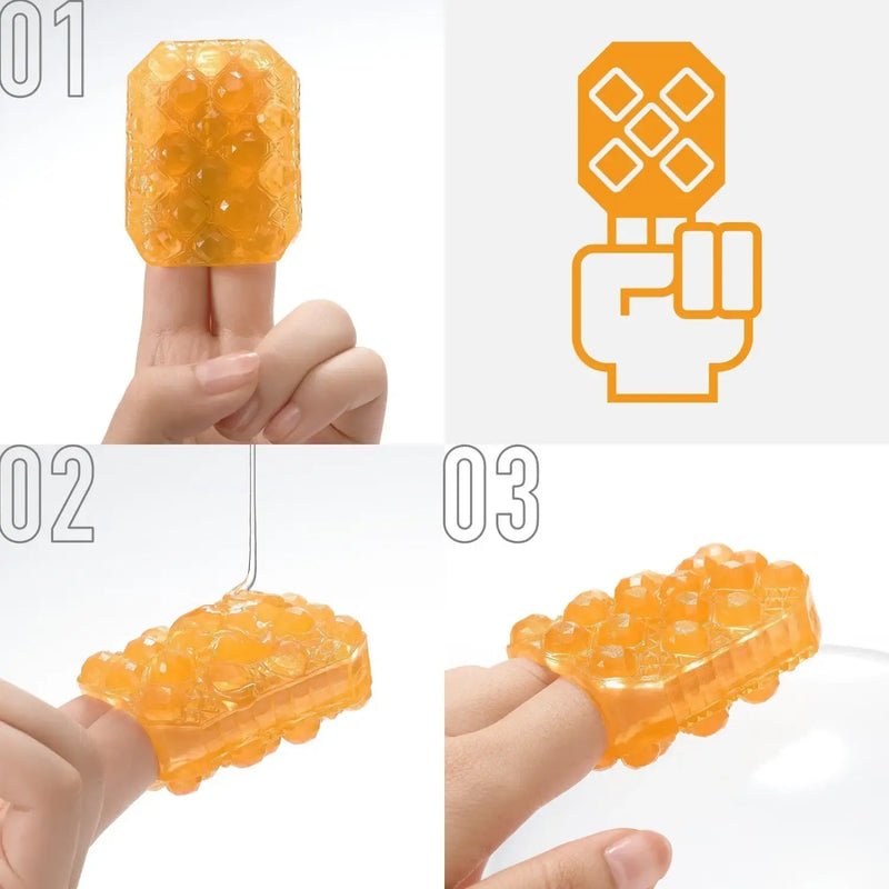 Orange translucent TENGA UNI TOPAZ sex toy with bead-filled rectangular finger massager