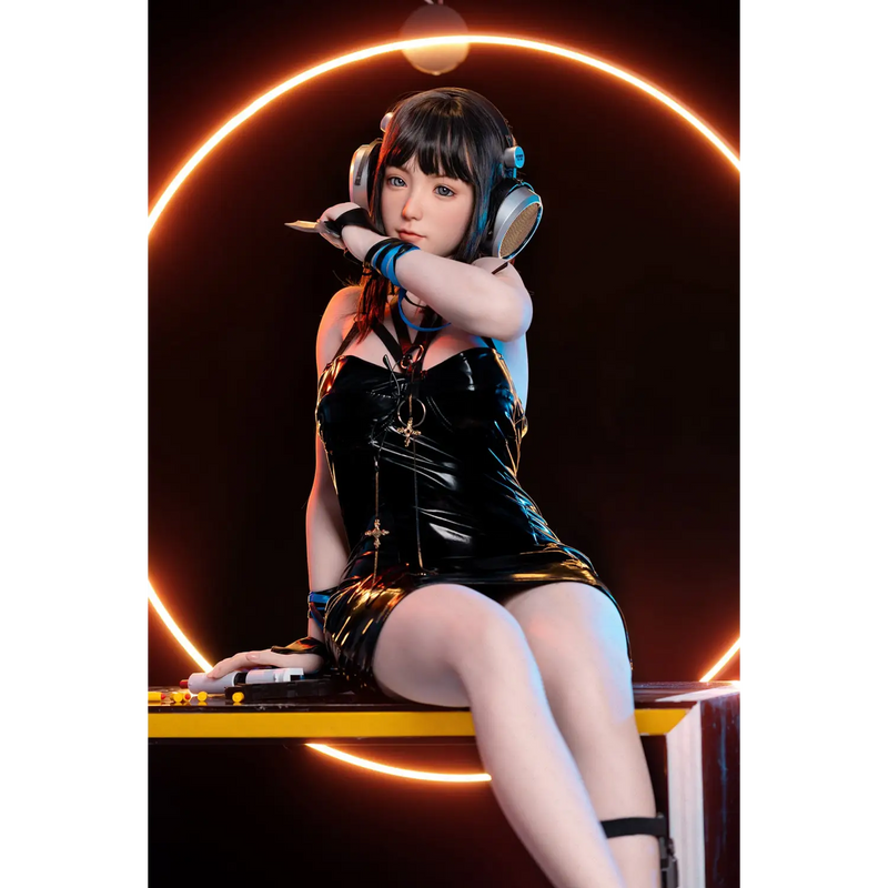 Aitia Silicone sex doll in black patent leather dress with silver hardware and large headphones