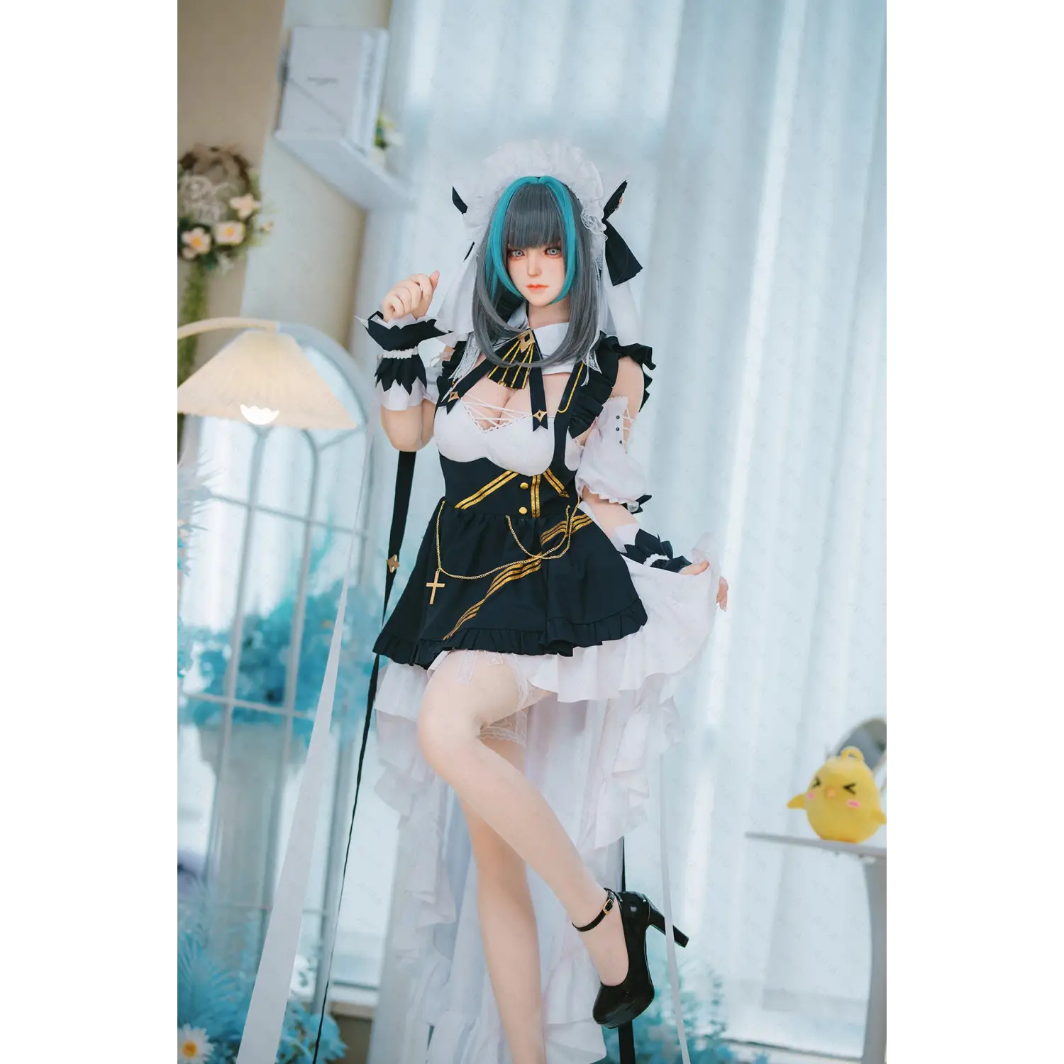 Black and white lace AITIA Cheshire silicone sex doll with gold accents, feathered cuffs